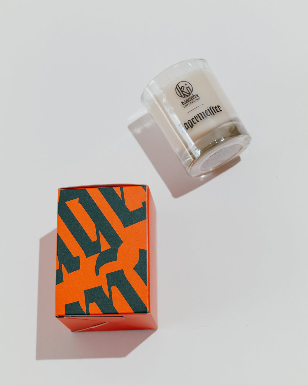 Jägermeister-kaars met decoratieve doos met Jägermeister-wordmark in groen en oranje