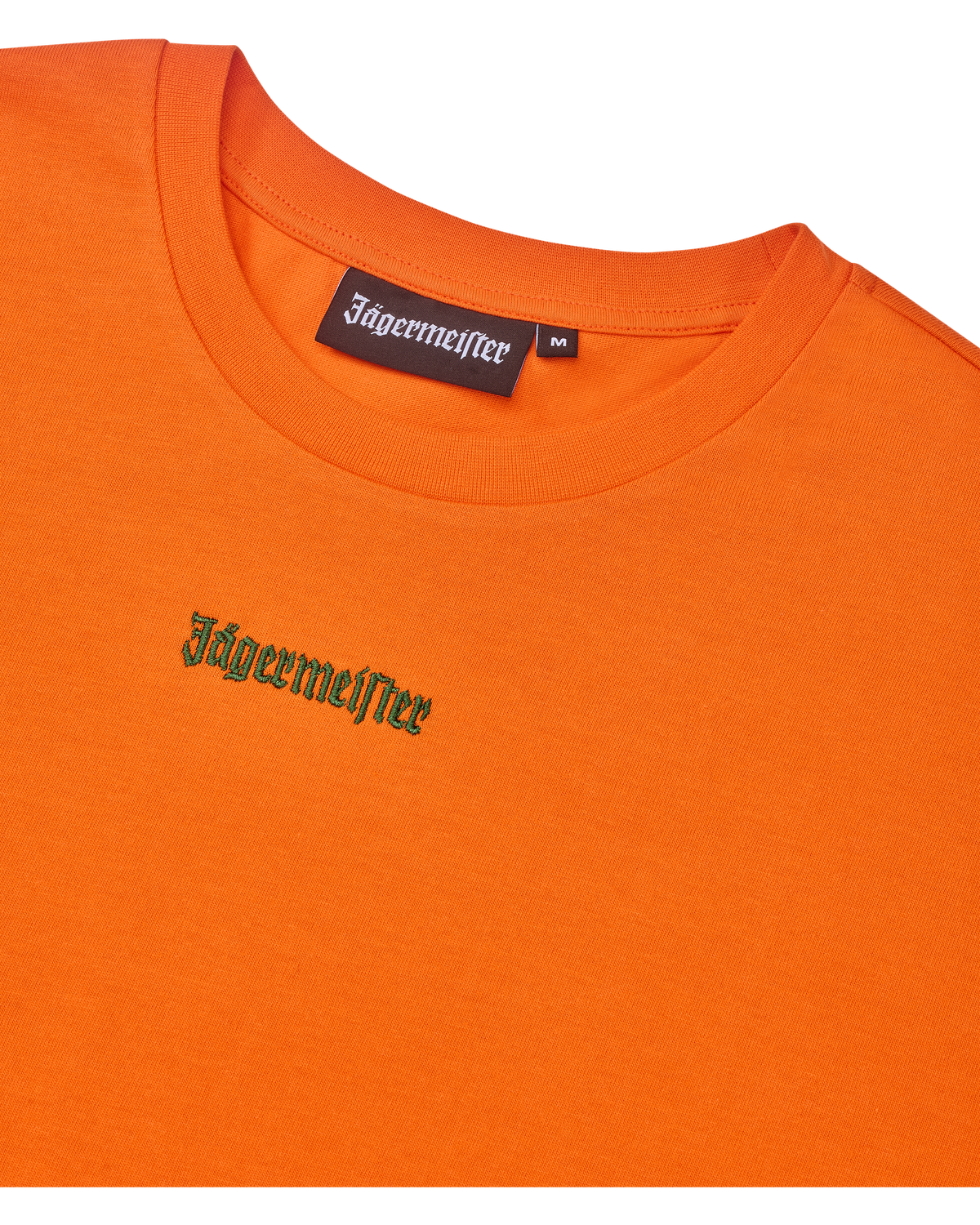 Orange cropped tee with green Jägermeister logo.
