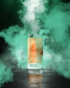 Jägermeister bottle with Pantone color label surrounded by green smoke on a dark background