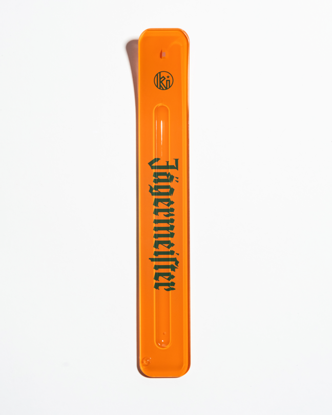 Orange incense stick holder with green 'Jägermeister' branding on a white background
