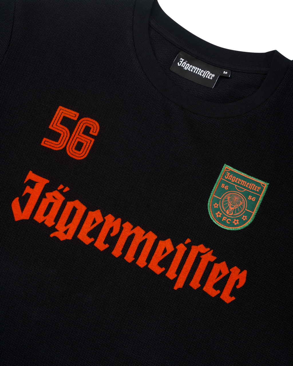Zwarte Jägermeister-longsleeve met oranje branding en logo.
