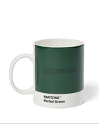 Jägermeister-mok met Pantone Herbal Green-kleurstaal op een witte achtergrond