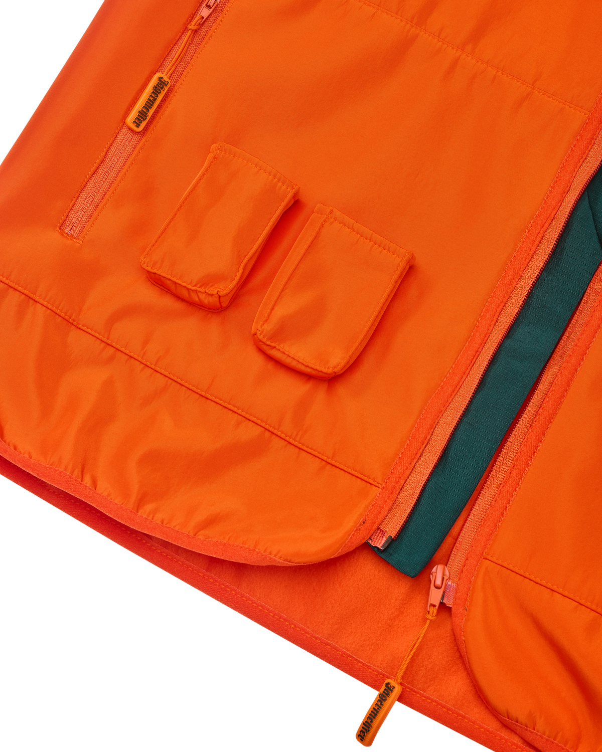 Close-up van een oranje Jägermeister-vest met twee voorzakken voor Jägermeister Minis.