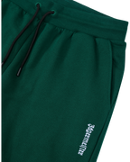 Groene Jägermeister-sweatpants met een wit logo.