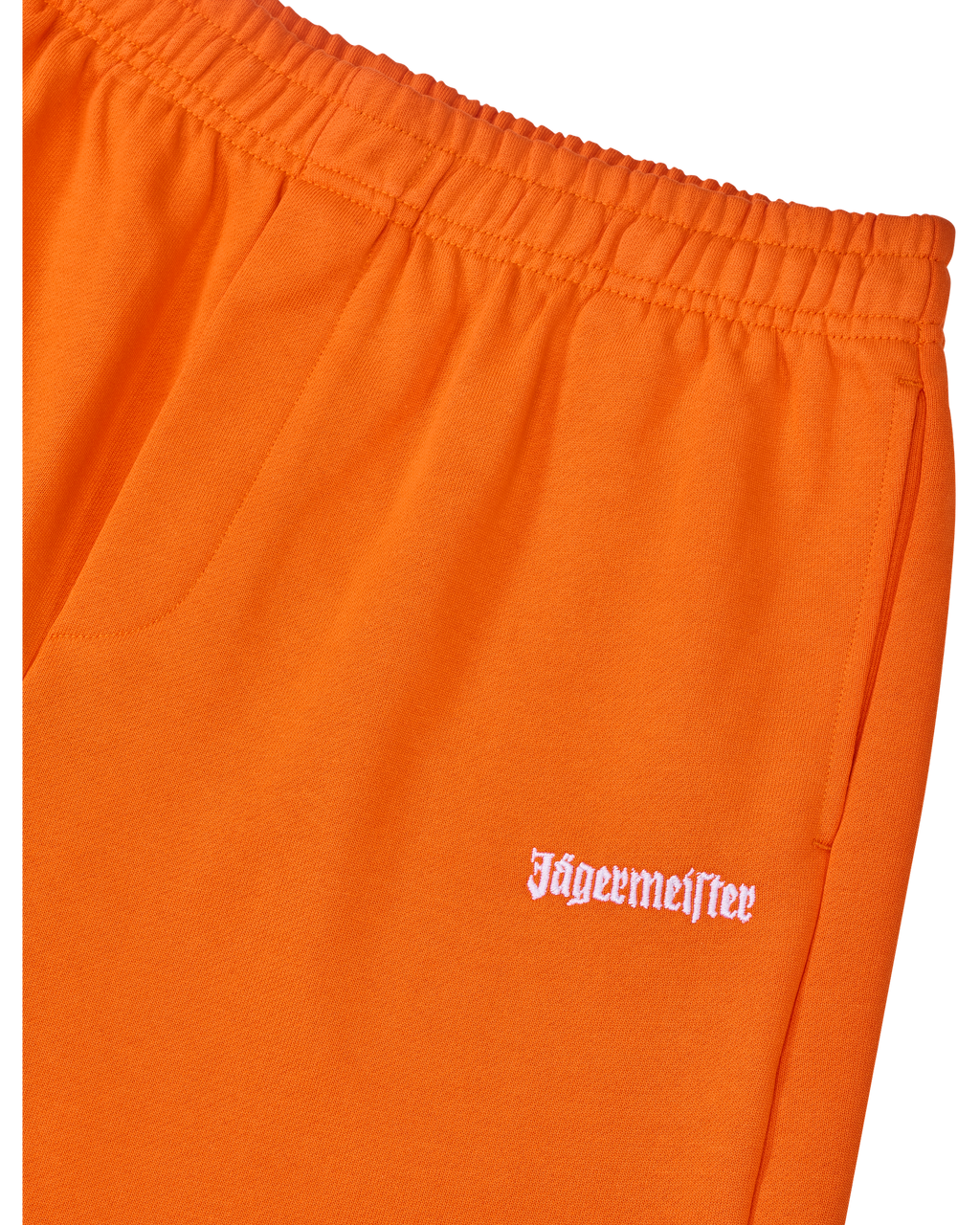 Oranje trainingsbroek met wit Jägermeister-logo op de zijkant.