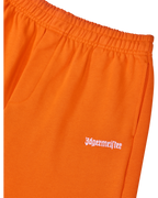 Oranje trainingsbroek met wit Jägermeister-logo op de zijkant.